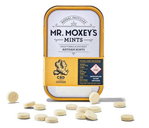 white and orange vertical tin of mints, with a handful of mints scattered in front