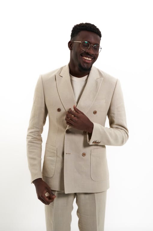 a Black man smiles in a dress suit made of hemp
