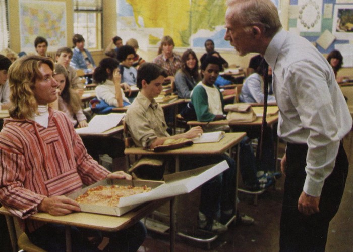 Sean Penn (as Jeff Spicoli) is chewed down by his teacher for showing up baked to class and ordering a pizza to his desk. (universal images)