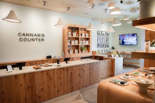 shop interior, lots of wood and a big shelf full of ceramic deli jars