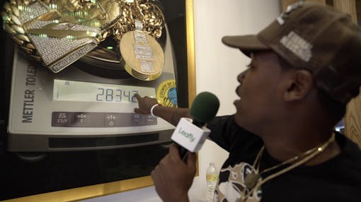 Leafly contributor Mikhail Harrison admires the artwork in TMC's dispensary. (Amennu McGruder/Leafly)