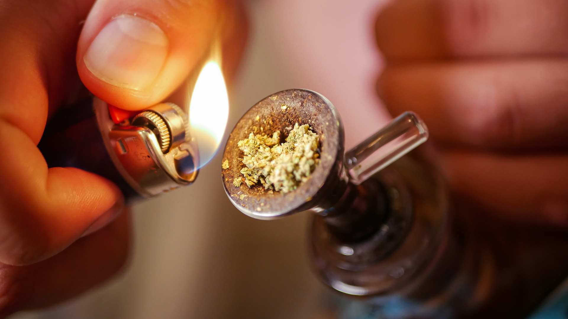 Hand putting a lighter in a bowl