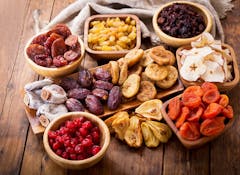 various dried fruits on wooden table, top view