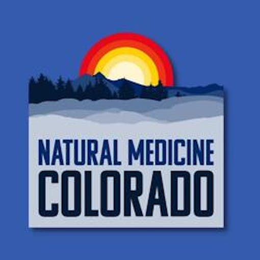 logo for natural medicine colorado, words over blue background and sun rising over mountains