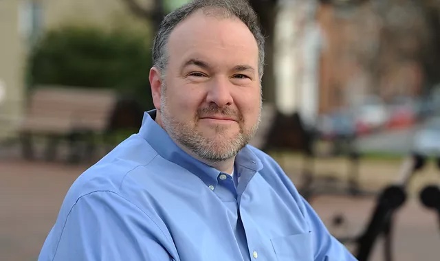 White man in blue button down