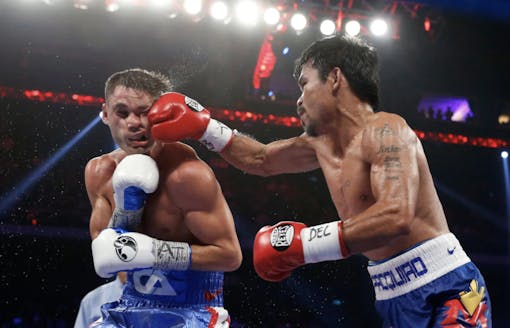Manny Pacquiao landing a punch on Chris Algieri. For the ninth consecutive time, Pacquiao failed to score a knockout. (Kin Cheung / Associated Press)
