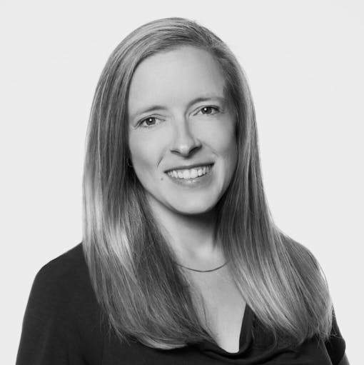 black and white headshot of smiling woman