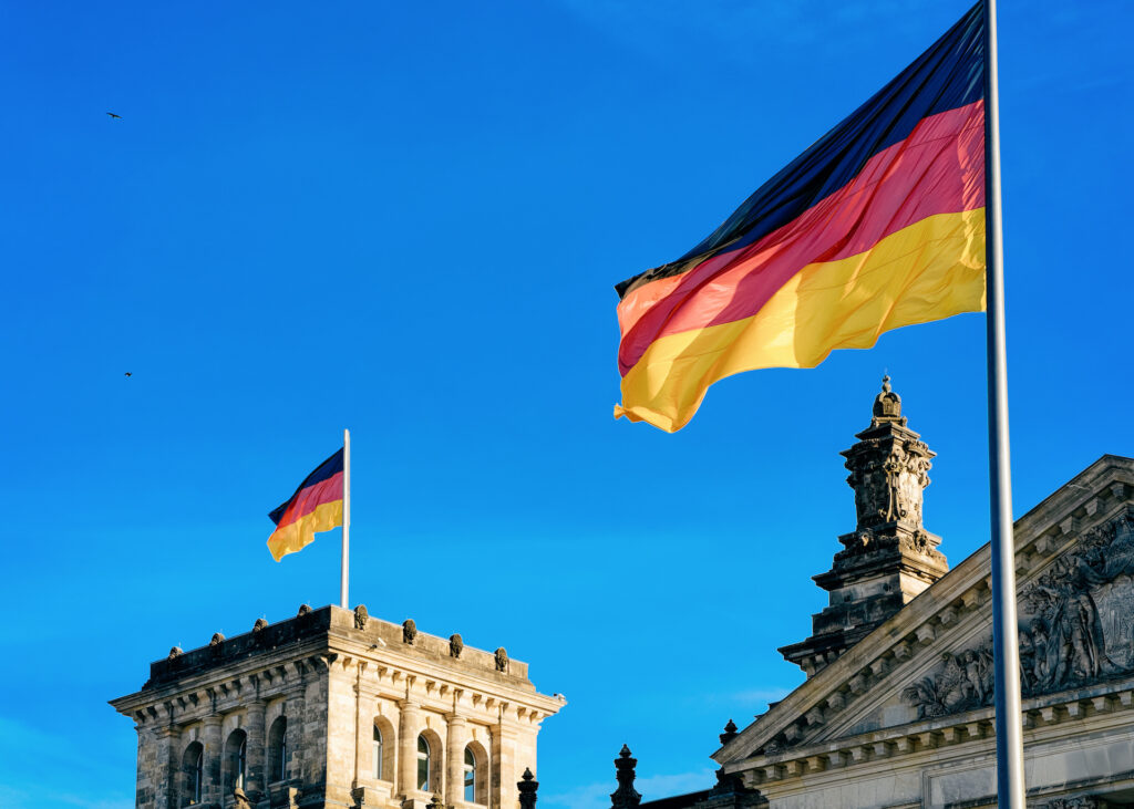 Reichstag building architecture with German flags in the city center of Berlin, capital of Germany in winter on the street. Parliament building of the German Bundestag.