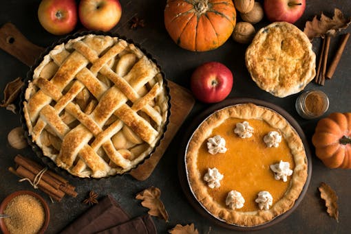 Thanksgiving pumpkin and various apple pies