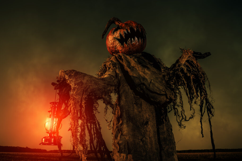 Portrait of a scary jack-lantern with a pumpkin on his head. halloween legend.