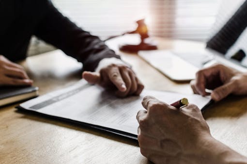 client customer signing contract and discussing business with legal consultants, notary or justice lawyer with laptop computer and wooden judge gavel on desk in courtroom office, legal service concept