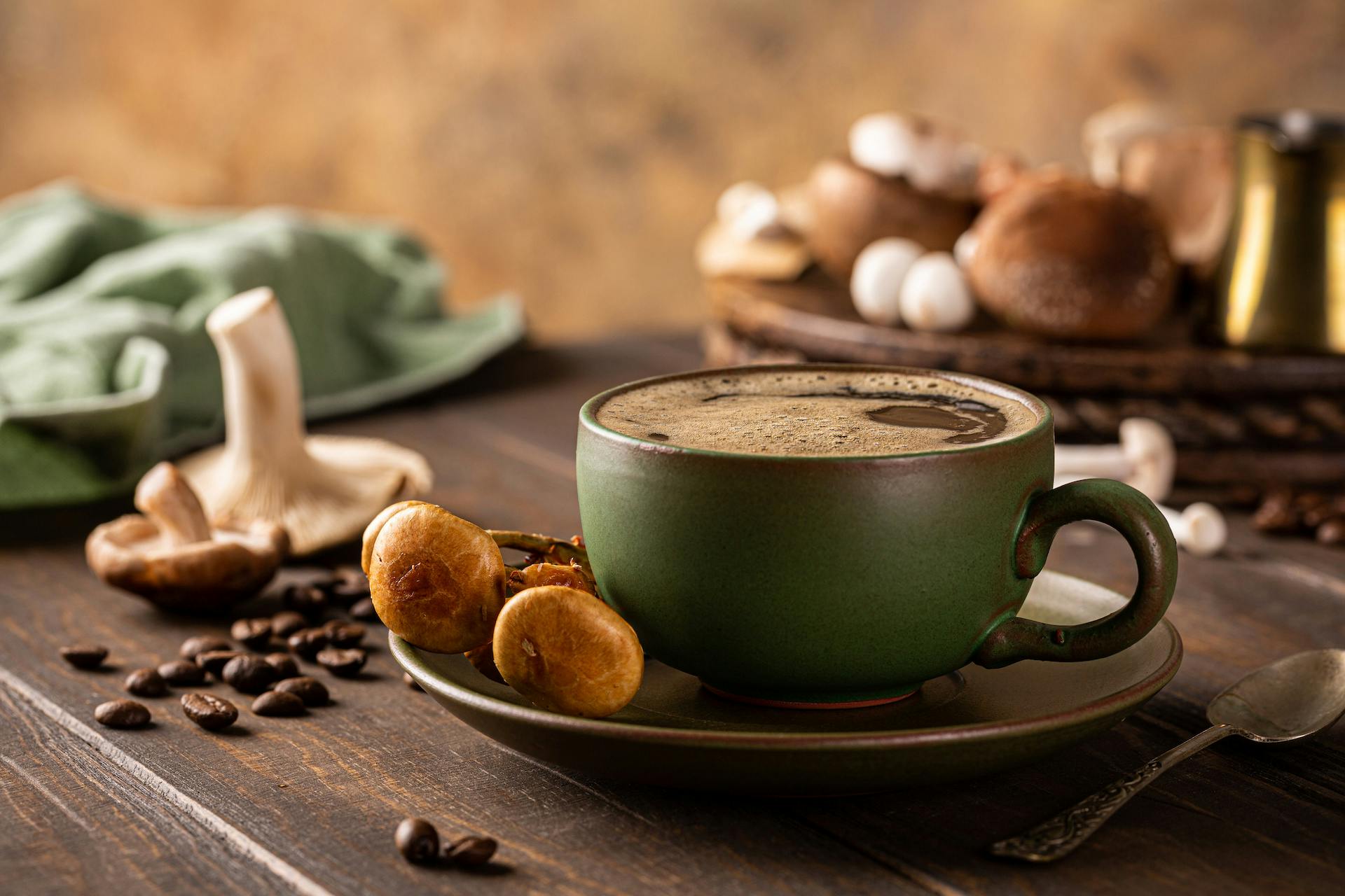 Mushroom coffee in green cup on wooden background. New Superfood trendy healthy concept with copy space, selective focus.