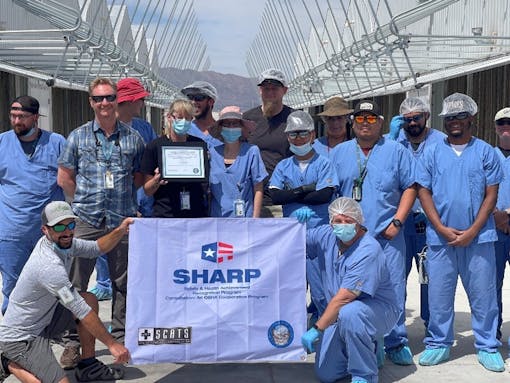 acres-workers-holding-their-sharp-flag