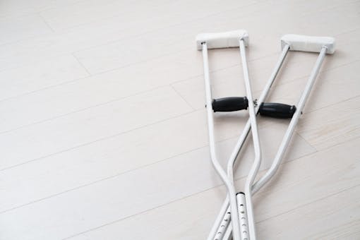 Set of crutches on off-white background