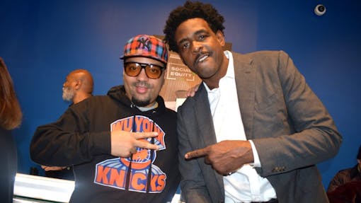 New York dispensary applicant Dorian (left) and basketball legend Chris Webber (right) pose for cameras at press event smiling. The state enlisted Webber’s firm Social Equity Impact Ventures to help raise private capital for its new dispensaries. (Calvin Stovall / Leafly)