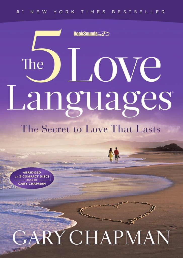 Photo of the cover of the book The 5 Love Languages by Gary Chapman. The cover is purple with a couple walking along the sea in the distance