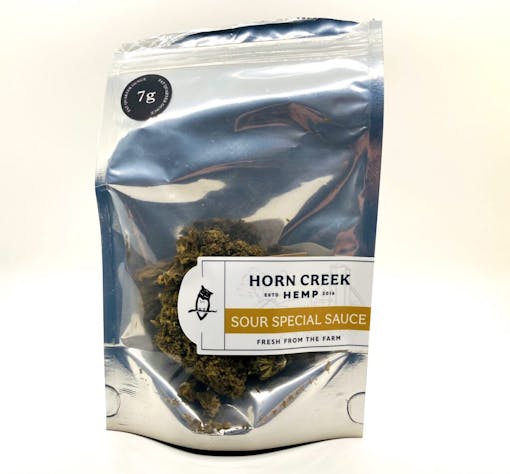 1 oz bag with buds behind clear plastic