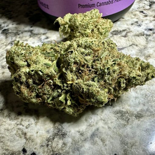 close up of bright green chunky nug on a marble tabletop