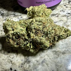 close up of bright green chunky nug on a marble tabletop