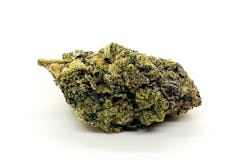 bright green marijuana nug resting on its side with splotches of purple against a white background
