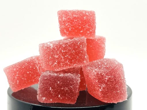 Red gummy bears on a black lid