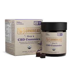 box of CORNBREAD CBD gummies next to a jar of CORNBREAD gummies with two individual dark purple gummies in front