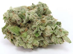 close up shot of frosty light green marijuana nug positioned horizontally against a white background