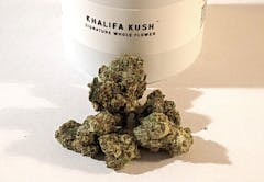 a few green nugs with white "Khalifa Kush" jar in background