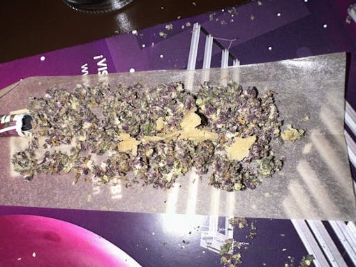 ground flower and hash on a rolled -up paper