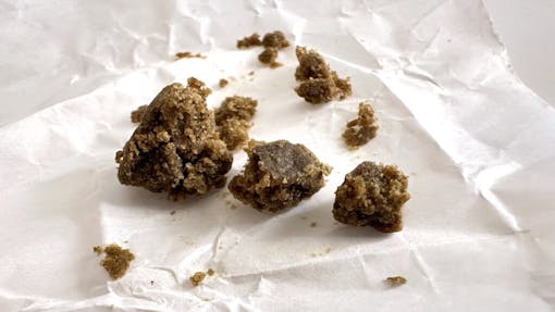 Brown, crumbly, oily pebbes of Highly regard Barbara Bud solventless hash from Strainhunters Club Barcelona. (David Downs/Leafly)