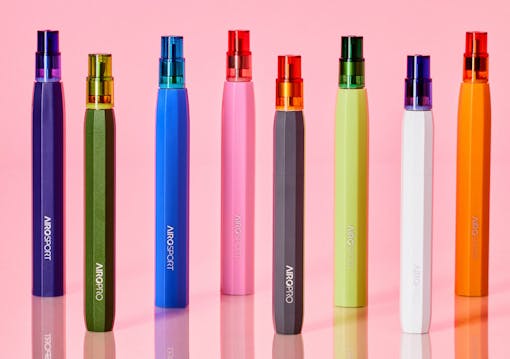 AiroPods vapes of various colors standing lined up against a pink background.