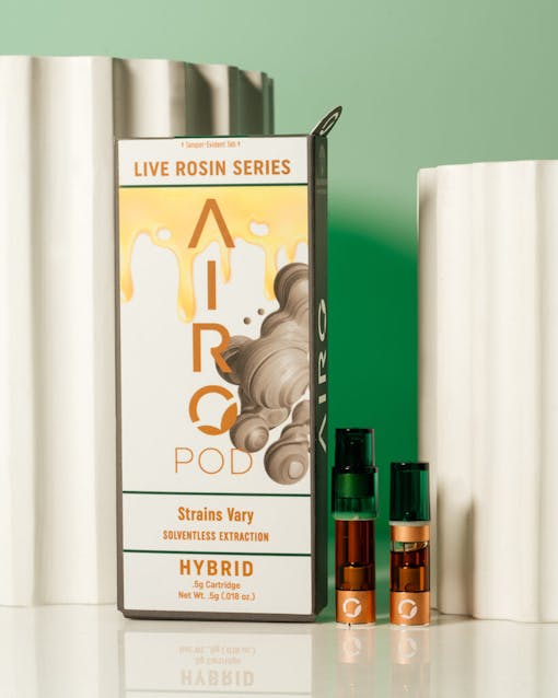 AiroPod Live Rosin vape product staged next to packaging against a light green background.