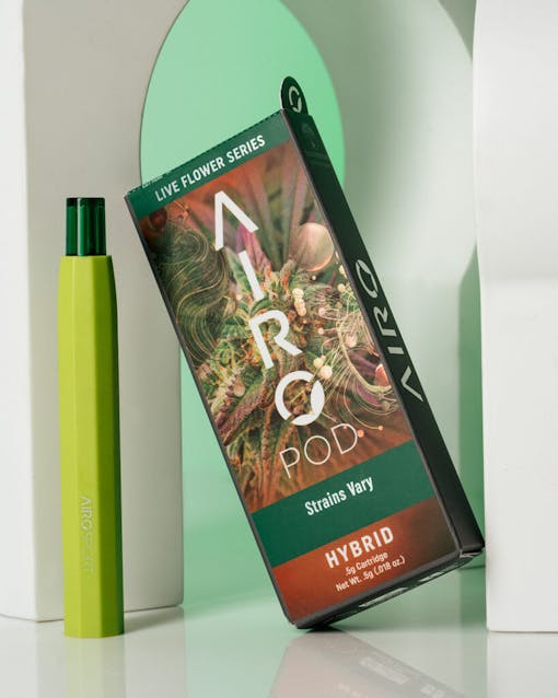 AiroPod Live Flower Series product staged alongside its packaging with white sculptural objects against a mint green background.