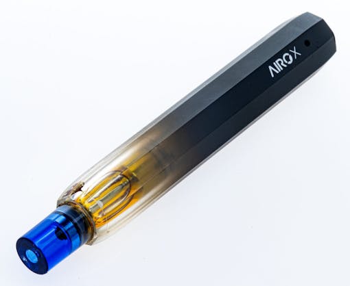 A blue-capped AiroX 1g vape pen angled horizontally down and to the left over a white background.