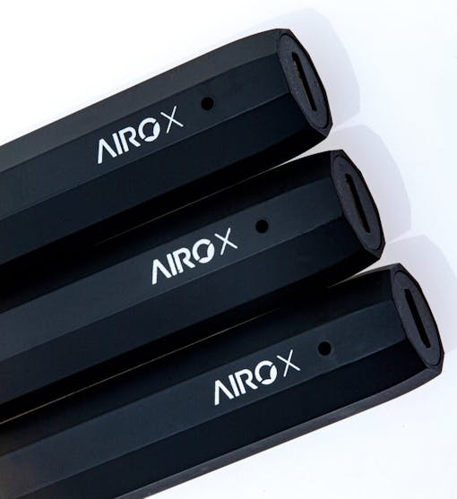 Three AiroX 1g vape pens stacked in a line over a white background, showing the bottom charging port of each device