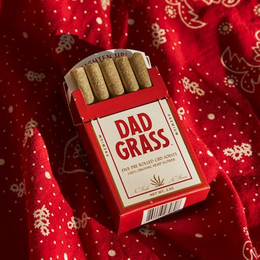 Dad Grass hard pack of 5 hemp pre-rolls laying on top of a red bandana
