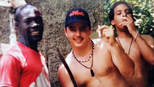A young Howie Rondinone shows off his cannabis and a machete while posing with his former business partners.