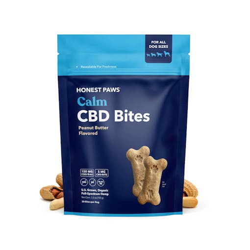 A blue resealable package of Calm CBD Bites for Dogs from Honest Paws, with peanuts placed around the packaging