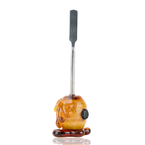 A dabber tool with intricate lampwork borosilicate glass made to look like a honey pot stands against a white background, one of our picks for the best products for Oil Day